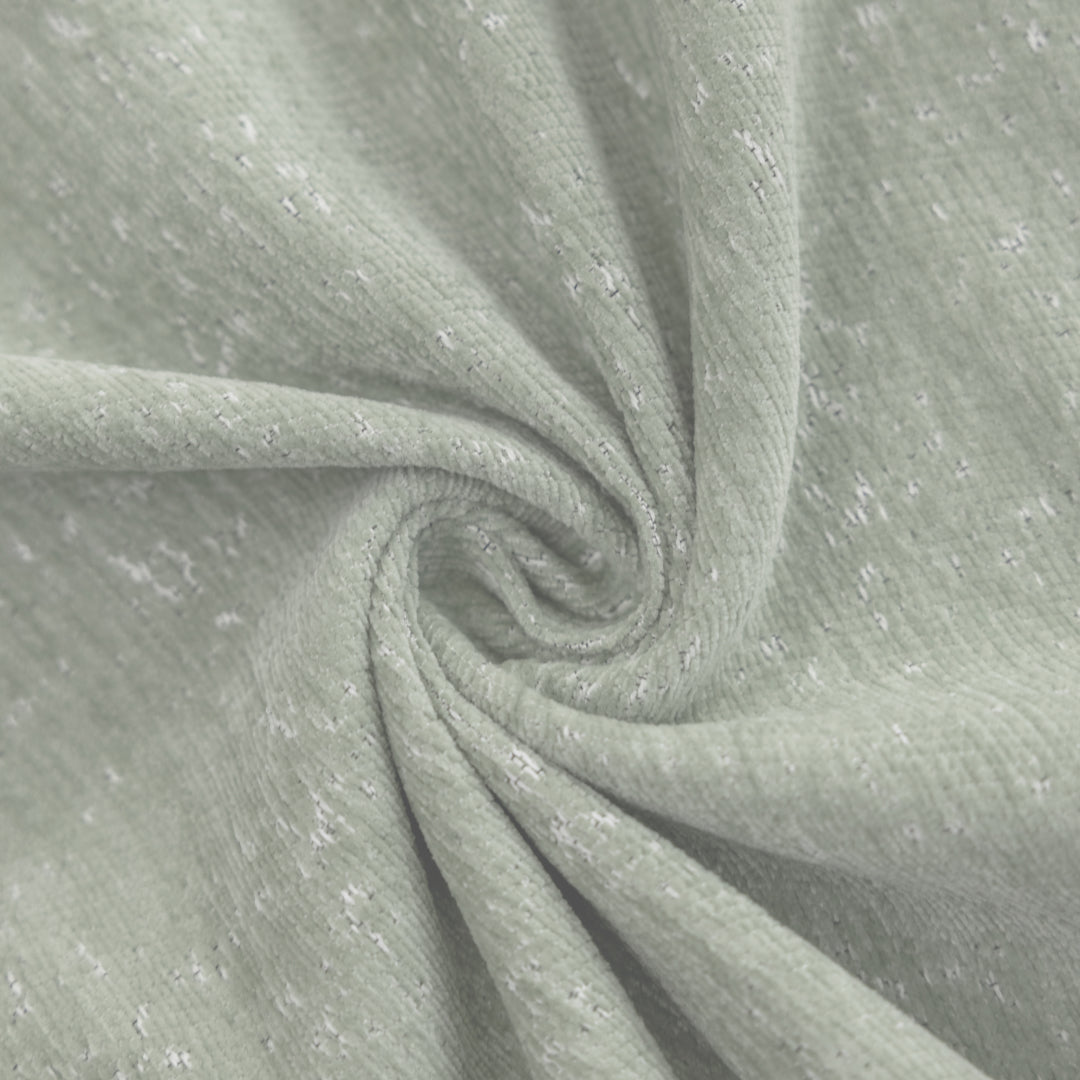 Close-up of the Kale Iris Sprinkle Magic Sofa Blanket fabric, sage green with white flecks