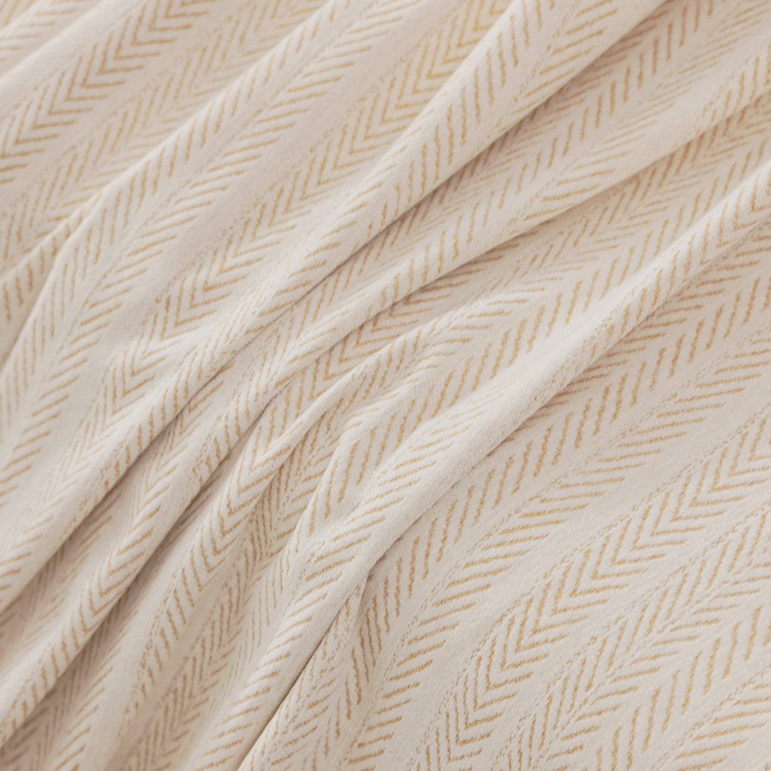 Close-up of Latte Lena Herring Magic Sofa Blanket fabric showing the herringbone weave