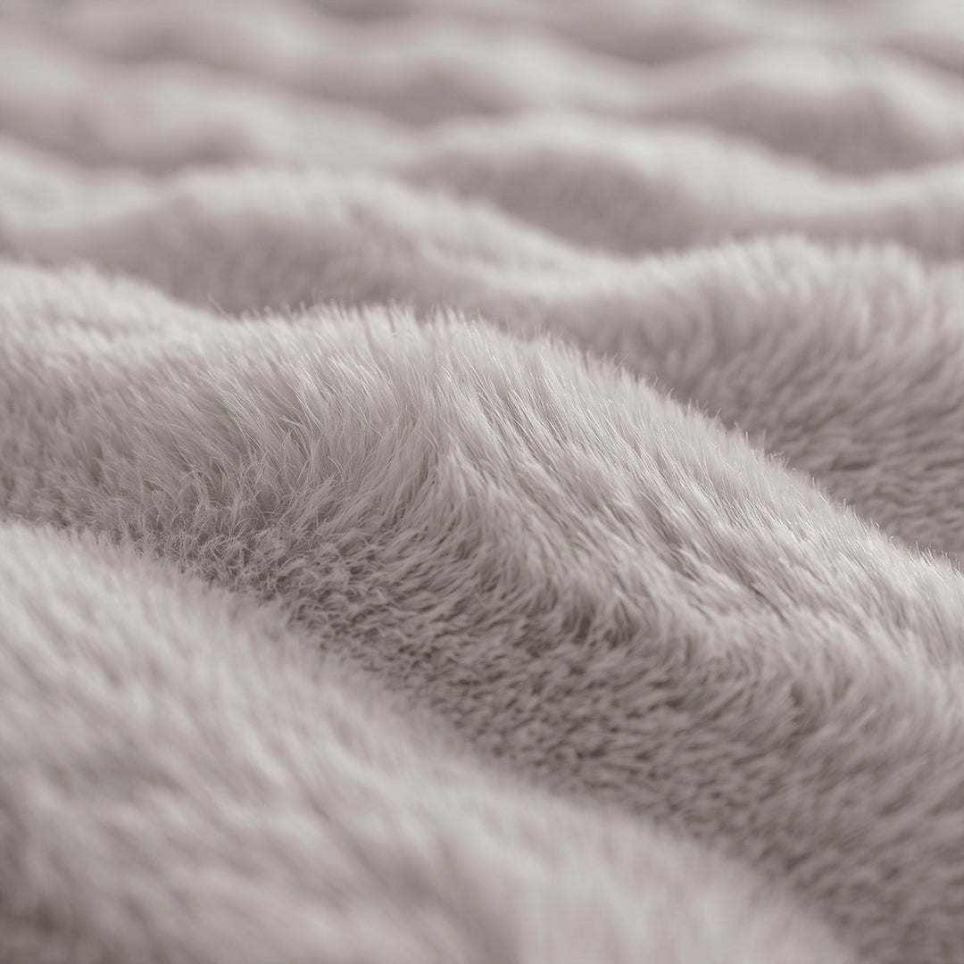 Close-up of the bubble-textured faux fur of the Oat Milk Nora Mink Magic Sofa Blanket