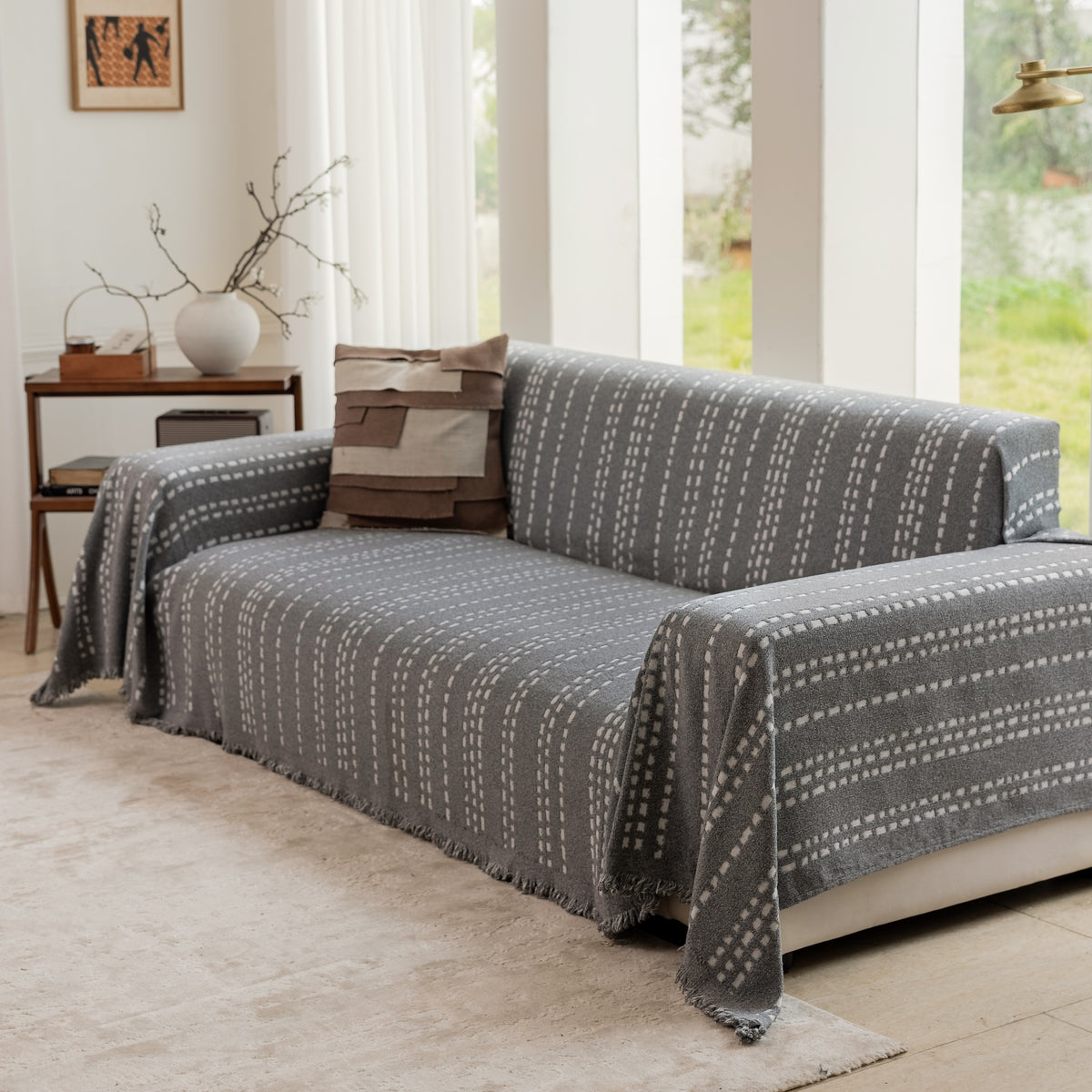 Close-up of the Sesame Noah Stitch Magic Sofa Blanket on a sofa