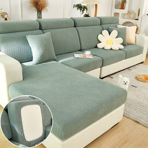 Green sectional couch cover in a contemporary living room setting.