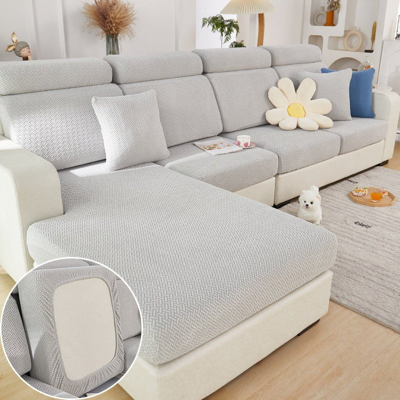 Light grey sectional couch cover in a contemporary living room setting.