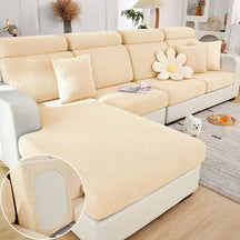Beige sectional couch cover in a contemporary living room setting.