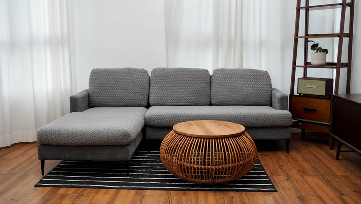 Wheat pattern Magic Sofa Cover in Charcoal Grey on a chaise sectional with a rattan coffee table