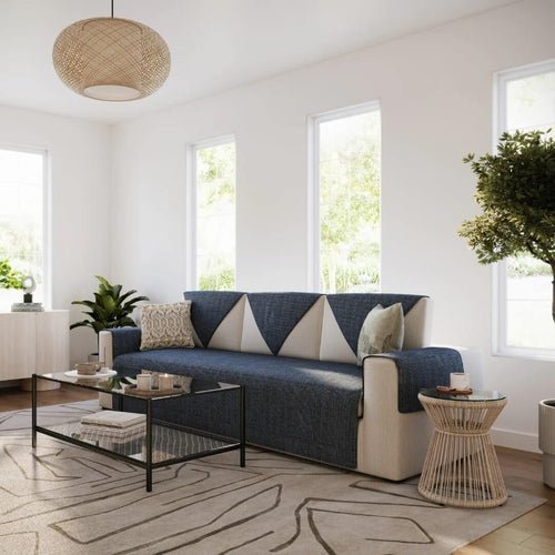Navy quilted cover on a cream sofa in a bright living room with tall windows
