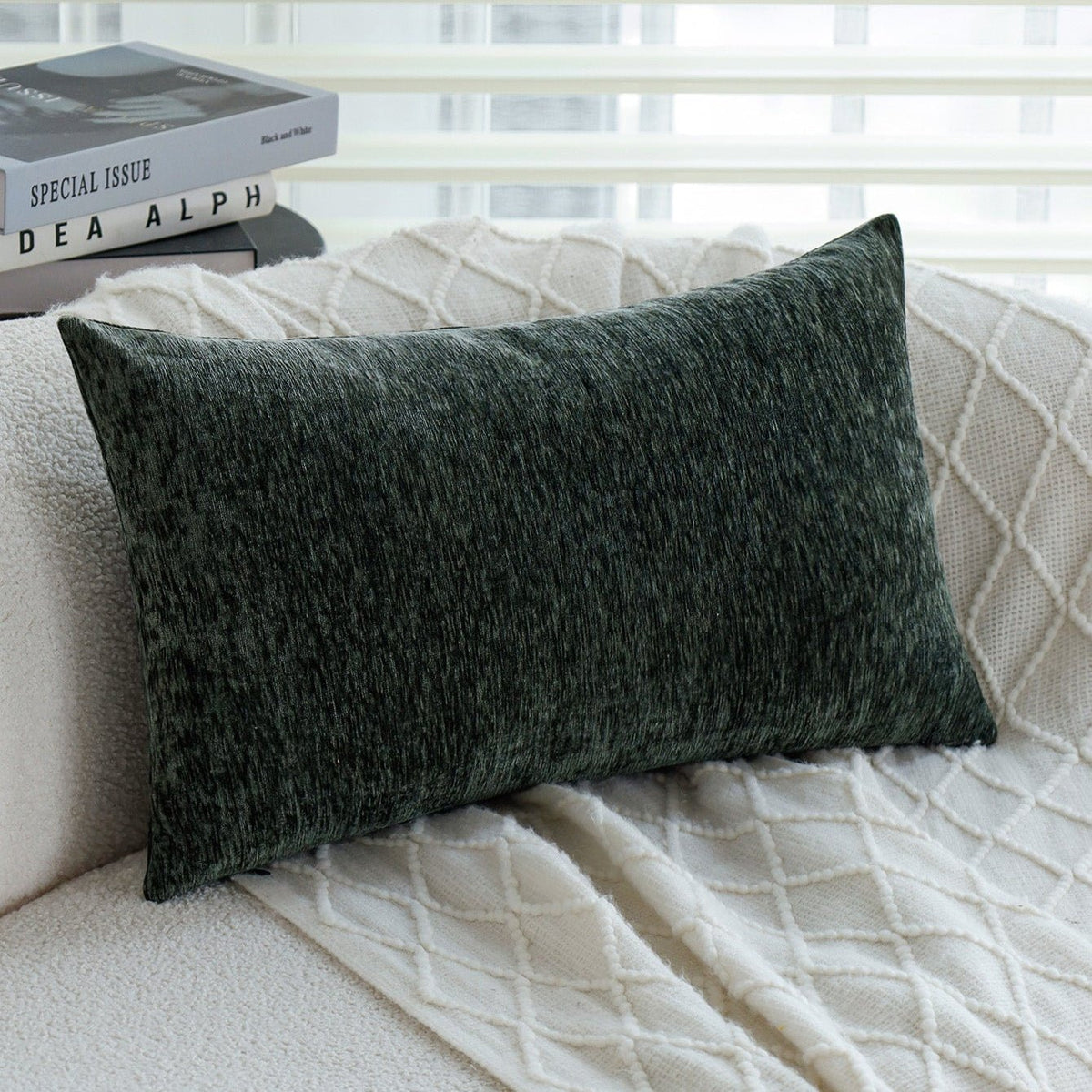 Woody lumbar pillow cover in Emerald on a cream boucle sofa with a white knit throw