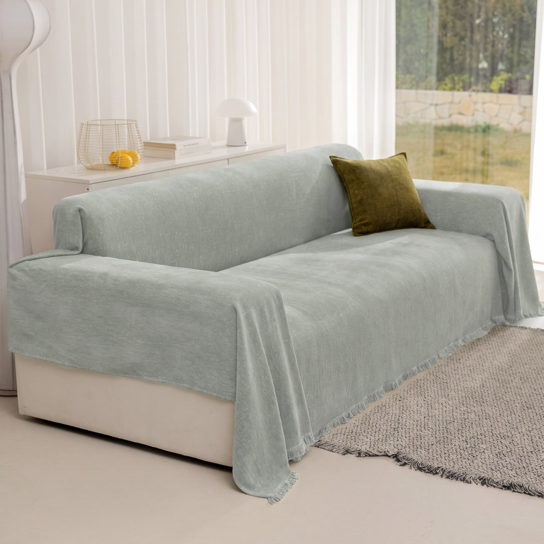 Kale Iris Sprinkle Magic Sofa Blanket covering a sofa with an olive green cushion