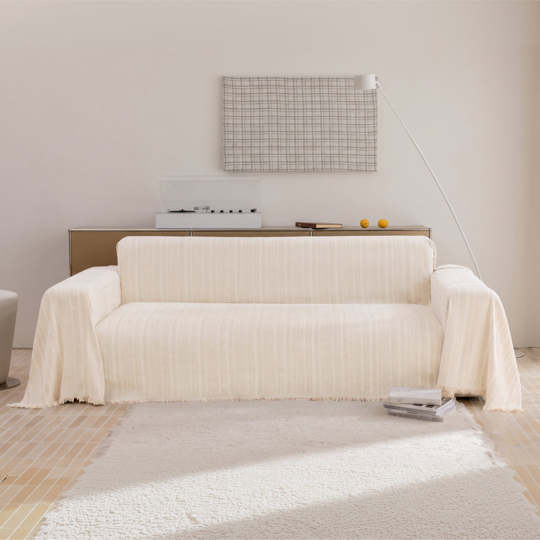 Latte Lena Herring Magic Sofa Blanket draped over a whole sofa, front view