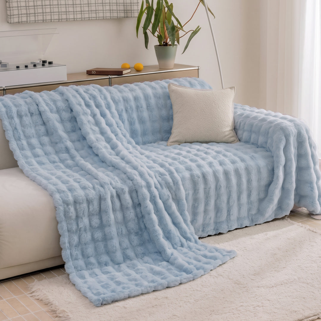 Celtic Salt Nora Mink Magic Sofa Blanket placed halfway over a sofa