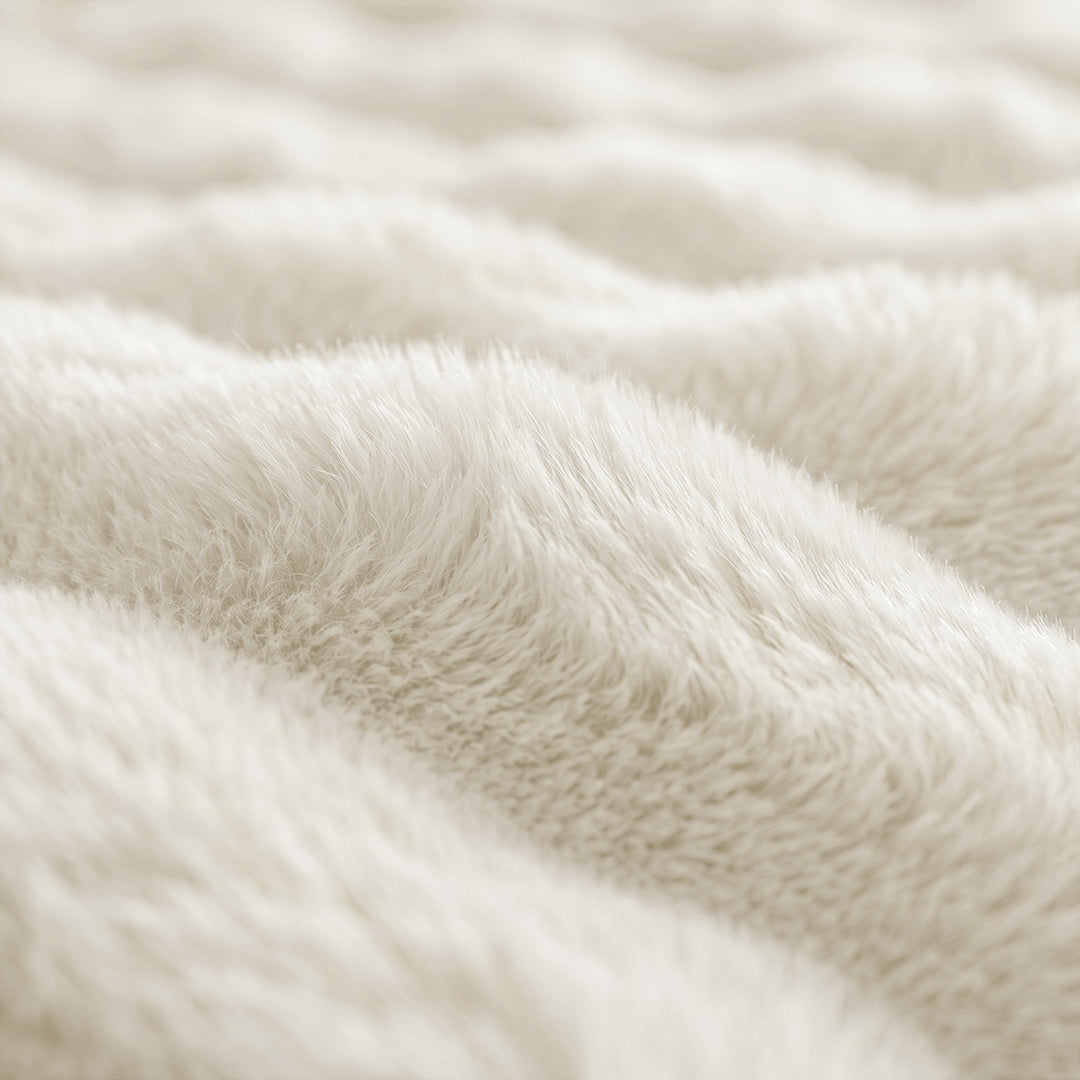 Close-up of the bubble-textured faux fur of the Vanilla Nora Mink Magic Sofa Blanket