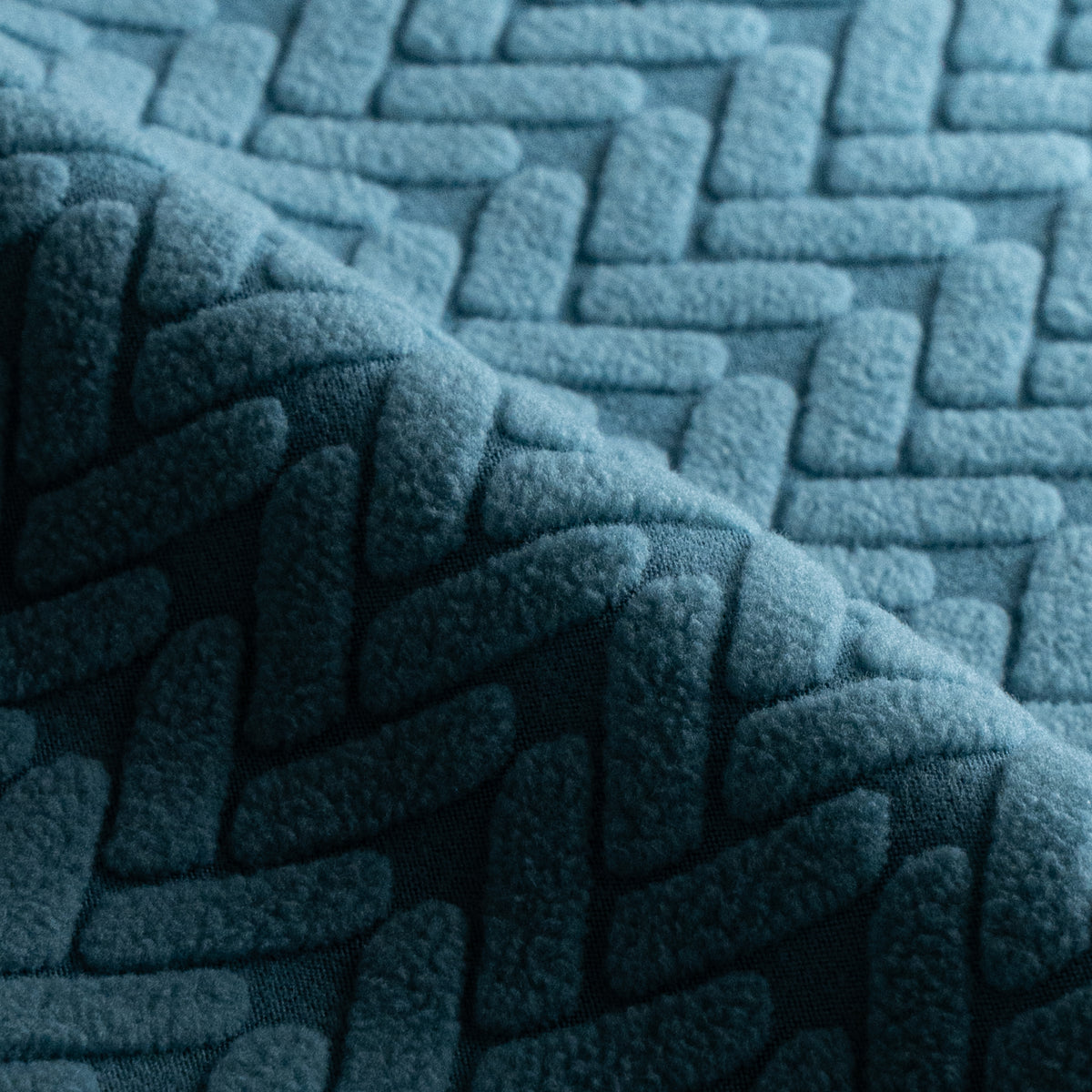 Close-up of folded Wheat pattern fabric swatch in Aqua Blue