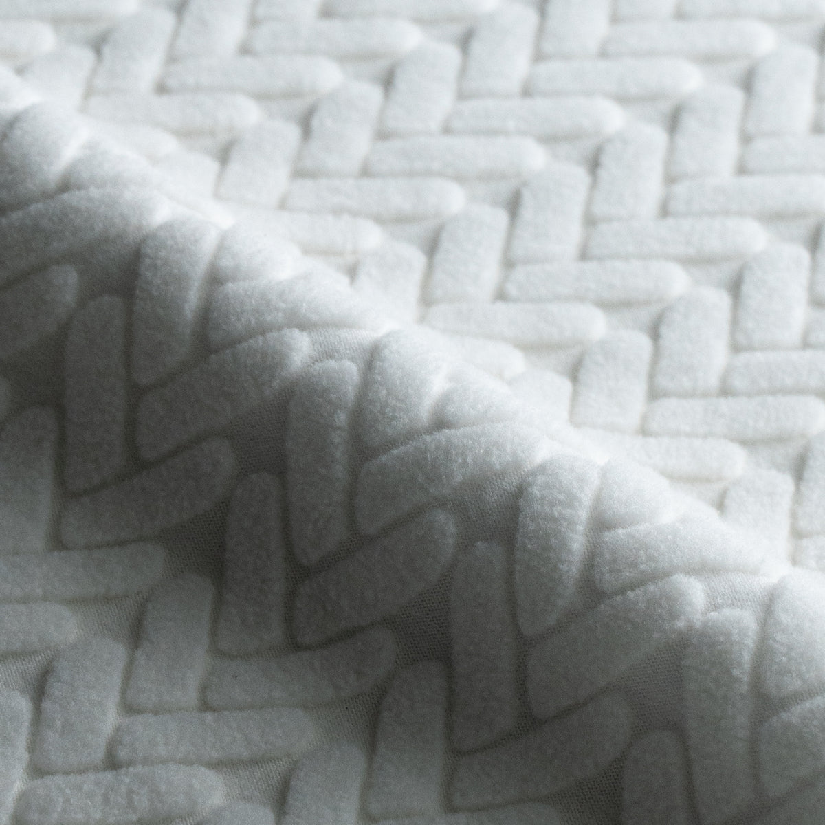 Close-up of folded Wheat pattern fabric swatch in Jade White