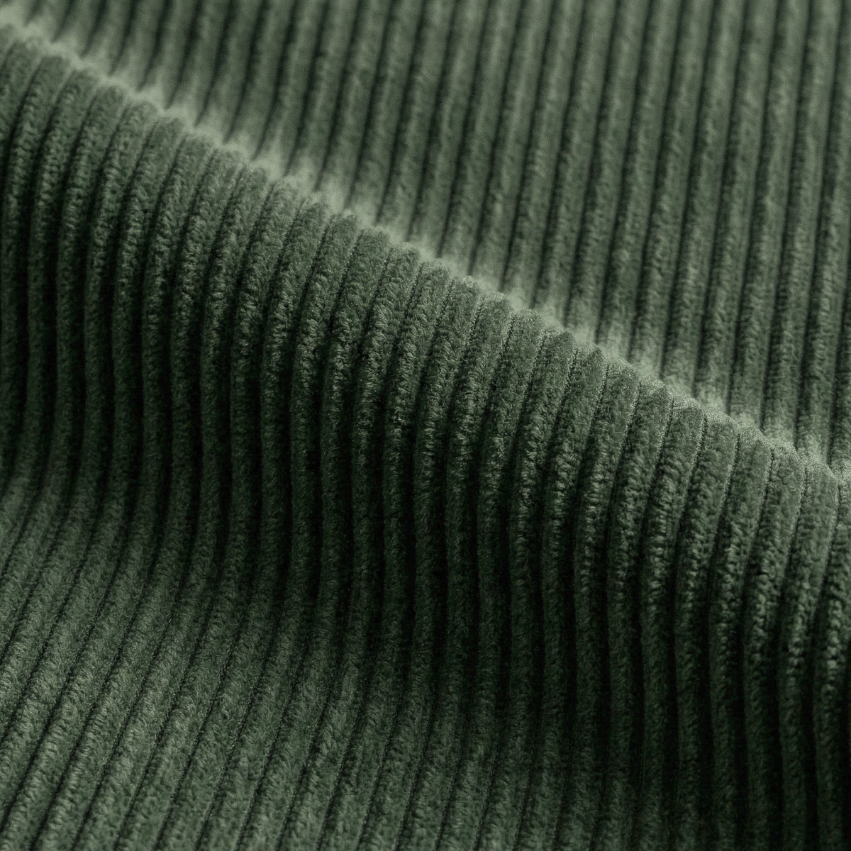 Corduroy fabric swatch in Kale draped in soft folds