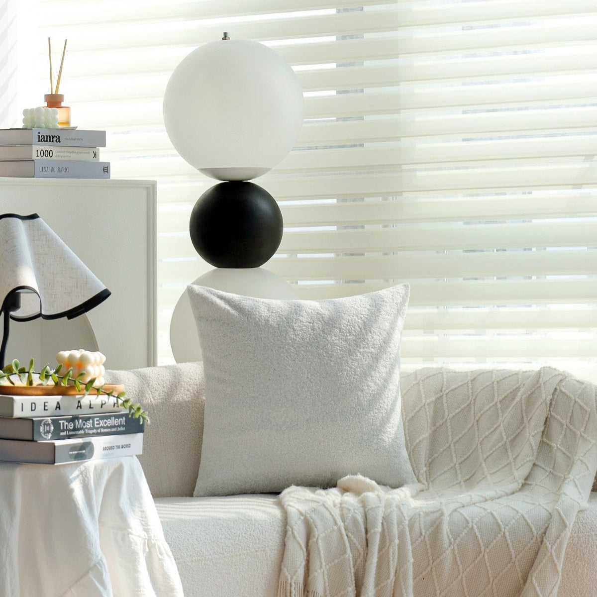 Teddy pillow cover in Pearl on a white sofa with a knit throw in a living room