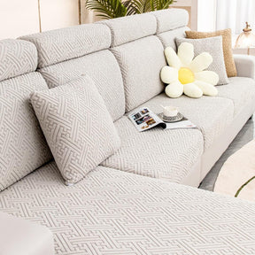 Light grey couch and sofa protector in a contemporary living room setting.