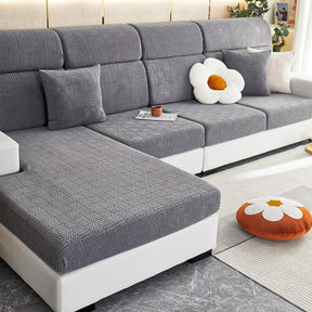 Dark grey stretchable couch cover in a contemporary living room setting.