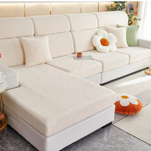 Beige stretchable couch cover in a contemporary living room setting.