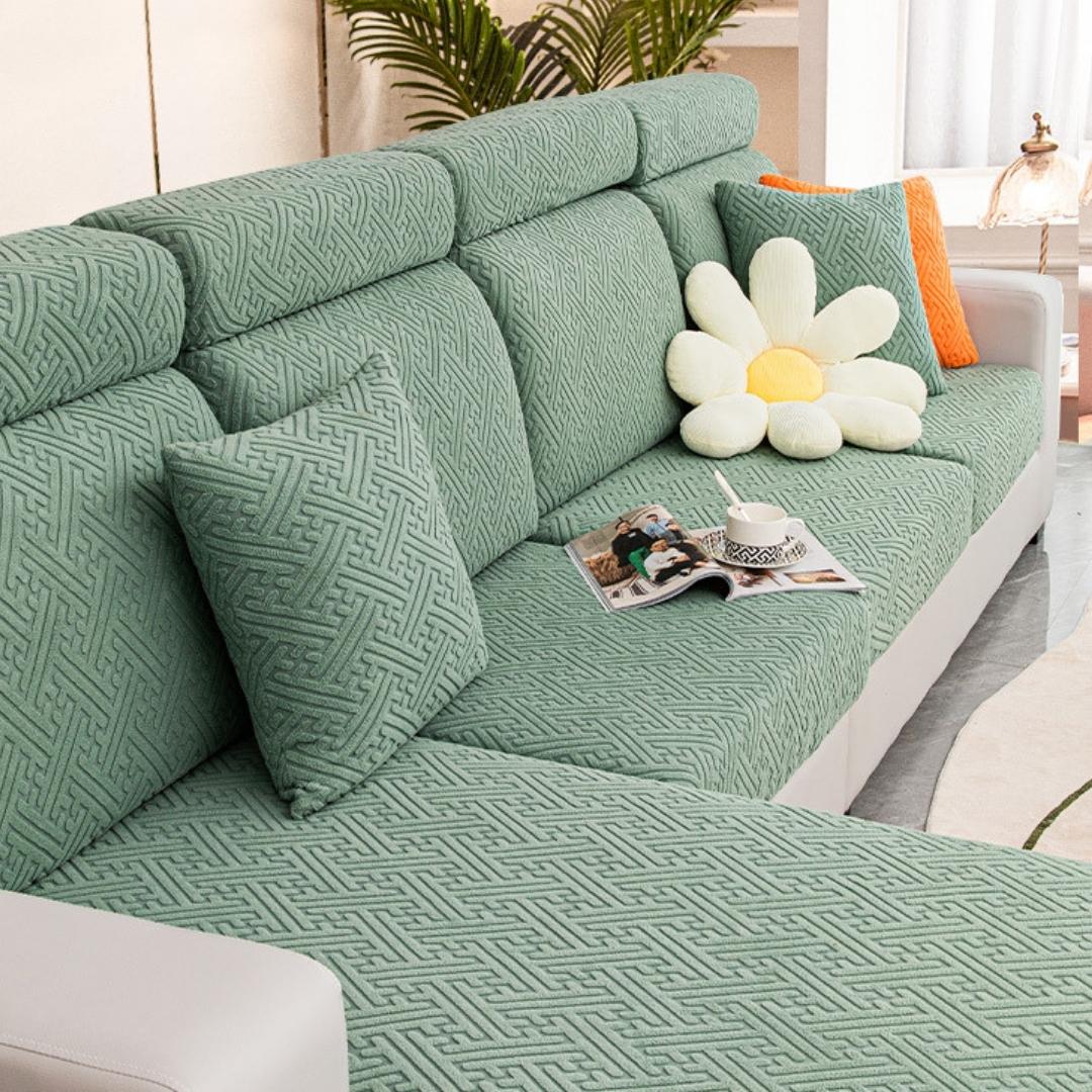 Green couch and sofa protector in a contemporary living room setting.