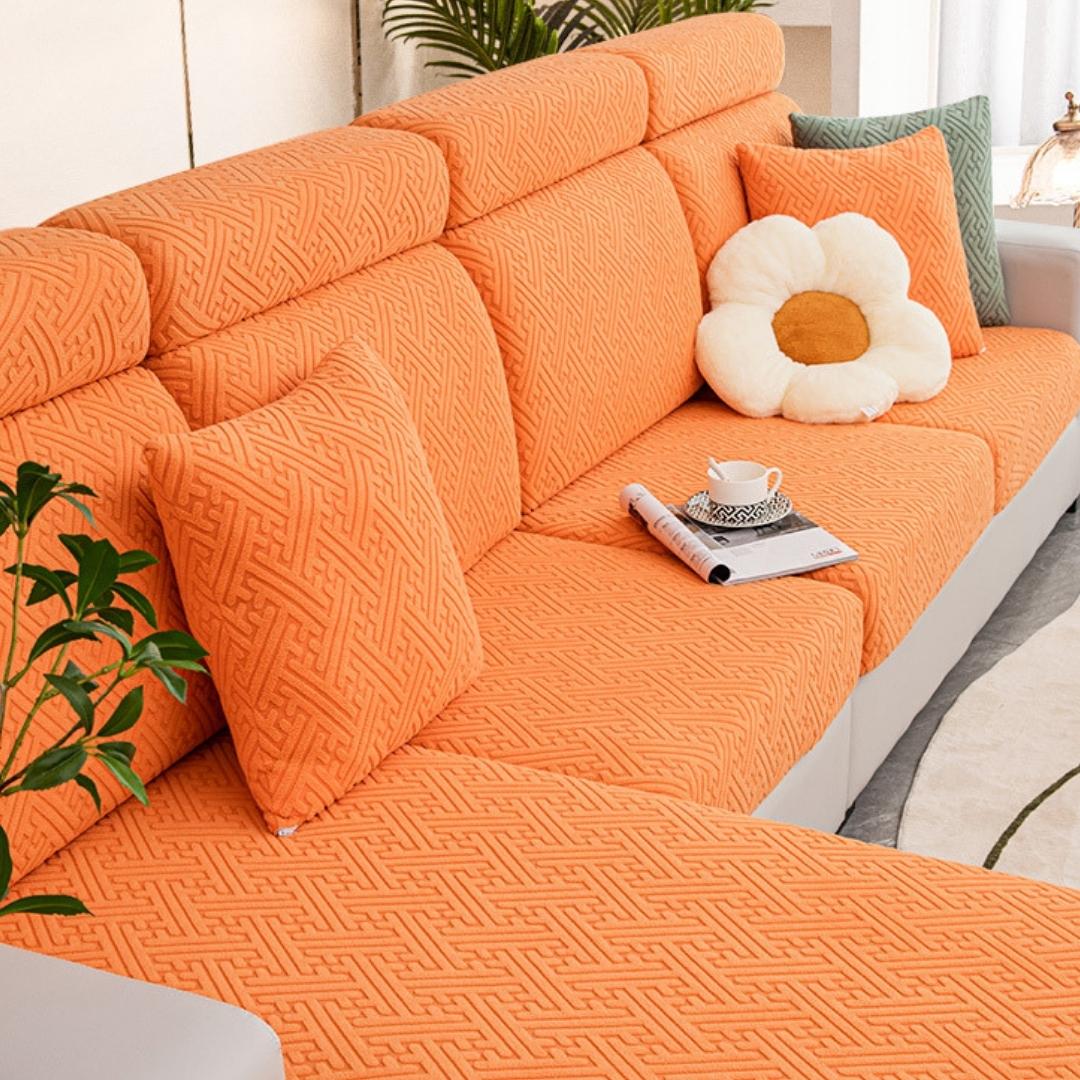 Orange couch and sofa protector in a contemporary living room setting.