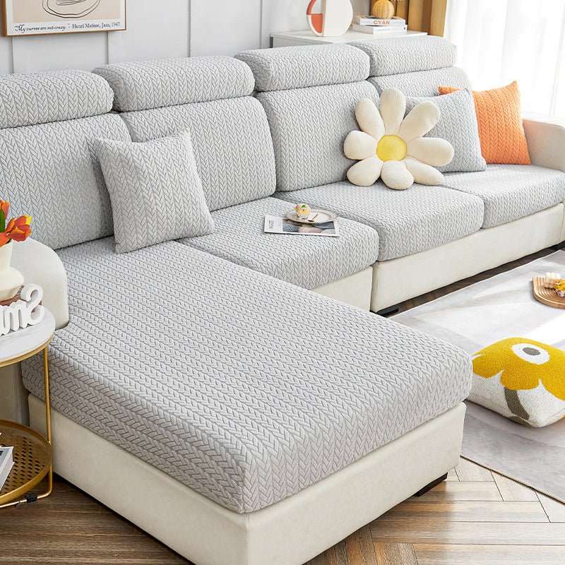 Light grey dog couch cover in a contemporary living room setting.