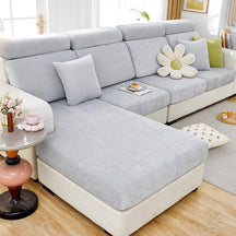 Light grey waterproof couch cover in a contemporary living room setting.