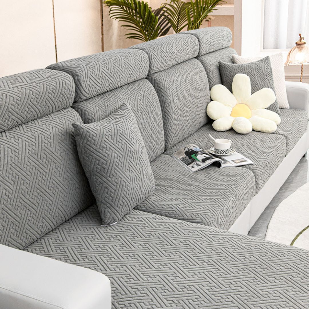 Dark grey couch and sofa protector in a contemporary living room setting.