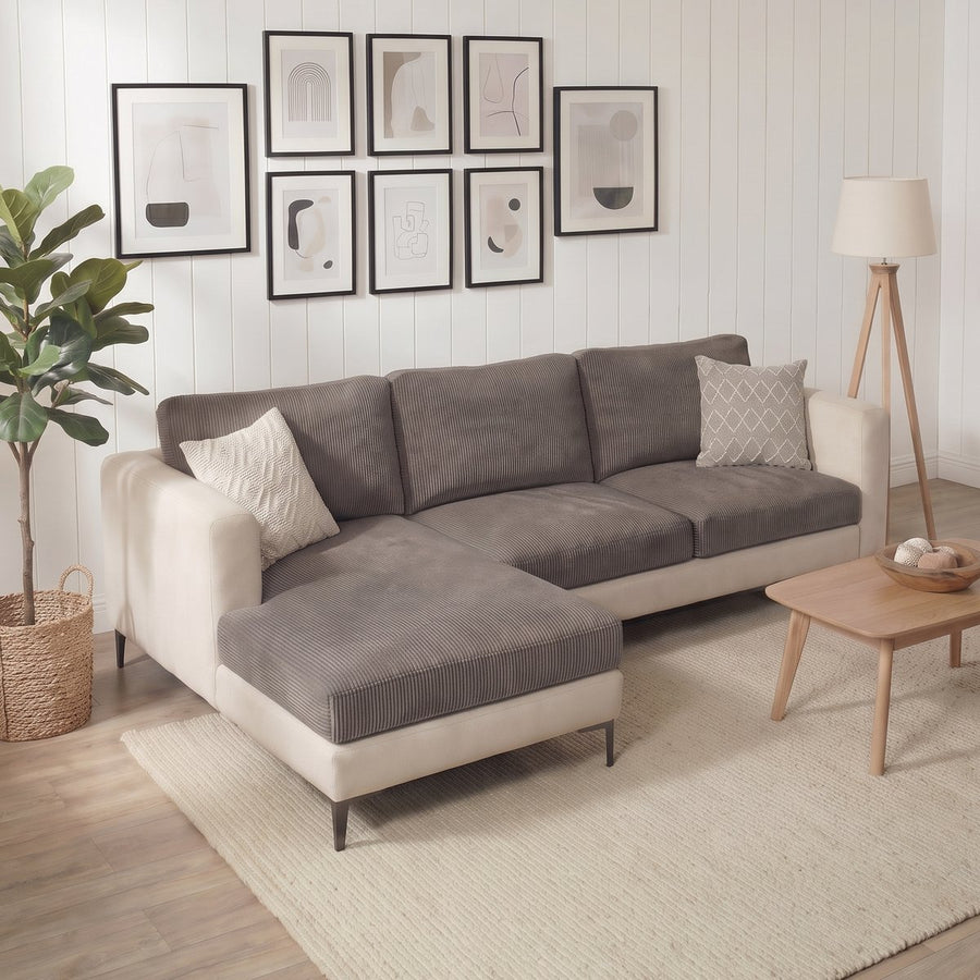 Miracle Sofa Cover Corduroy in taupe grey on a cream chaise sectional in a living room